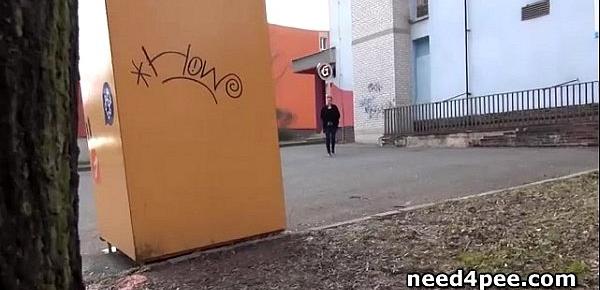  Amateur girl hides behind a wall to take a pee